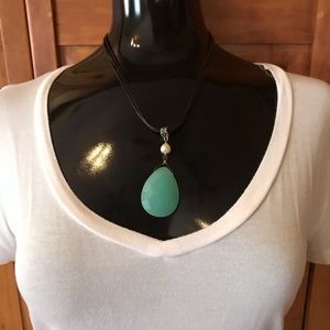 Rope necklace with turquoise- colored pendant